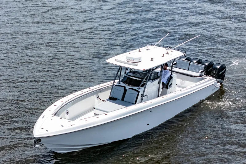 Slide: The Image of 2018 Nor-Tech 392 Super Fish boat cruising on open water, featuring sleek design and powerful engines. - 40