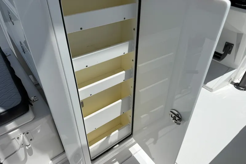 Slide: The Image of Open storage compartment on 2018 Nor-Tech 392 Super Fish boat, showcasing interior shelves. - 27