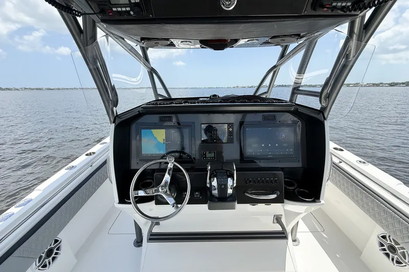 Slide: The Image of 2018 Nor-Tech 392 Super Fish boat dashboard with advanced navigation and control systems on open water. - 6