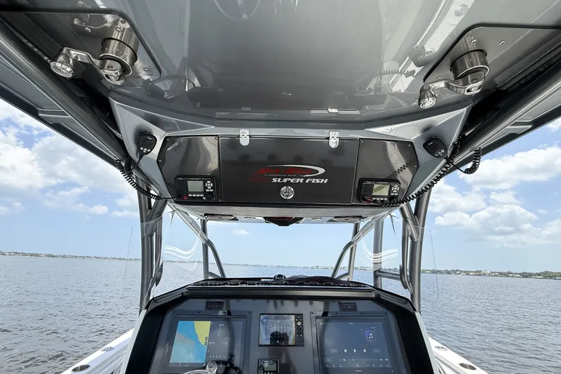Slide: The Image of 2018 Nor-Tech 392 Super Fish boat dashboard with navigation screens on open water. - 7
