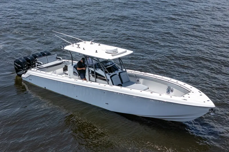 Slide: The Image of 2018 Nor-Tech 392 Super Fish boat on water, featuring multiple outboard engines. - 42
