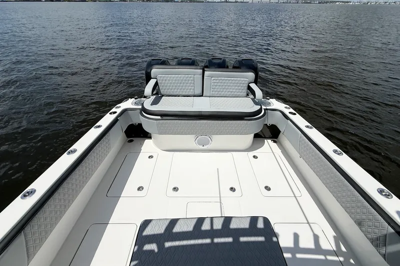 Slide: The Image of 2018 Nor-Tech 392 Super Fish boat interior with cushioned seating on calm water. - 10