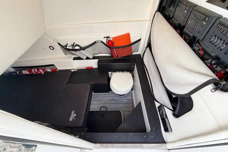 Slide: The Image of Interior of 2018 Nor-Tech 392 Super Fish boat with compact toilet and storage area. - 30