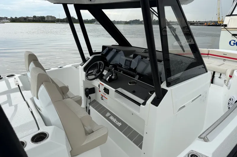 Slide: The Image of 2027 Wellcraft 28 T-Top boat interior with modern dashboard and seating. - 8