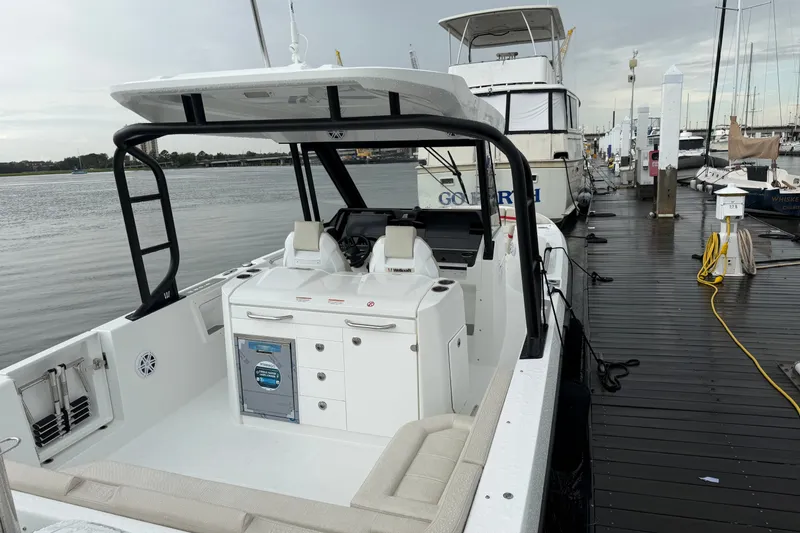 Slide: The Image of 2027 Wellcraft 28 T-Top boat docked at marina, showcasing sleek design and modern features. - 9