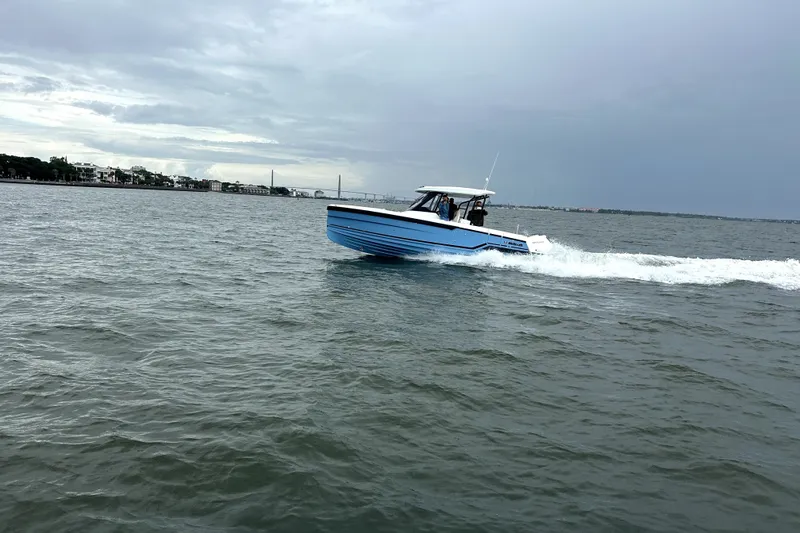The Image of 2027 Wellcraft 28 T-Top boat cruising on open water under cloudy skies. - 4