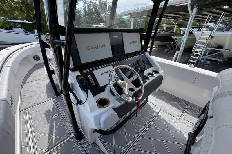 Slide: The Image of 2024 Fountain 34 Center Console boat interior with Garmin displays and Mercury controls. - 31
