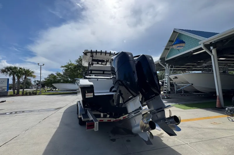 Slide: The Image of 2024 Fountain 34 Center Console boat with dual outboard motors at a marina. - 17