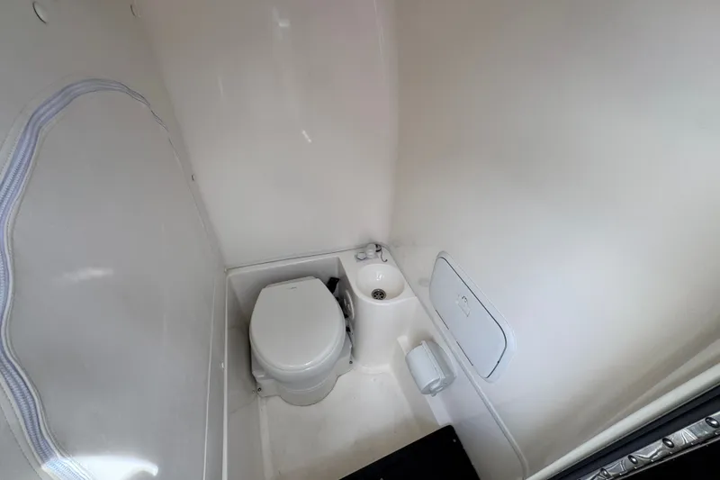 Slide: The Image of 2024 Fountain 34 Center Console boat interior bathroom with toilet and sink. - 29