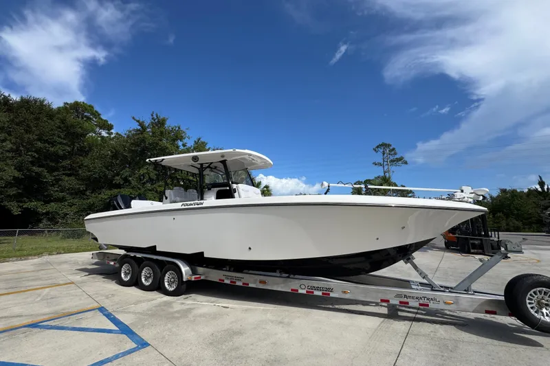 Slide: The Image of 2024 Fountain 34 Center Console boat on trailer under clear blue sky. - 10