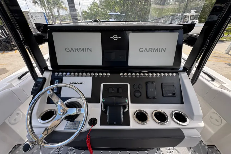Slide: The Image of 2024 Fountain 34 Center Console dashboard with Garmin displays and Mercury controls. - 32