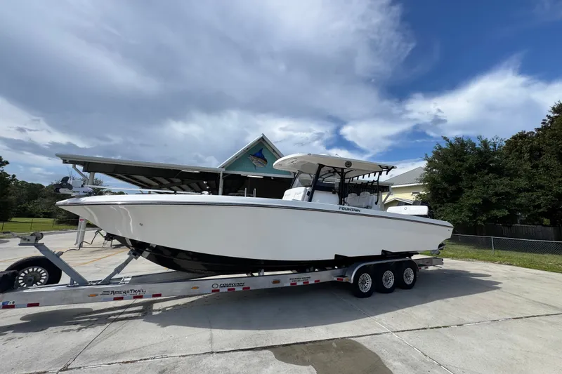 Slide: The Image of 2024 Fountain 34 Center Console boat on trailer under cloudy sky. - 3