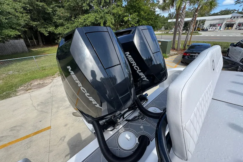 Slide: The Image of 2024 Fountain 34 Center Console with dual Mercury outboard engines, parked outdoors. - 47