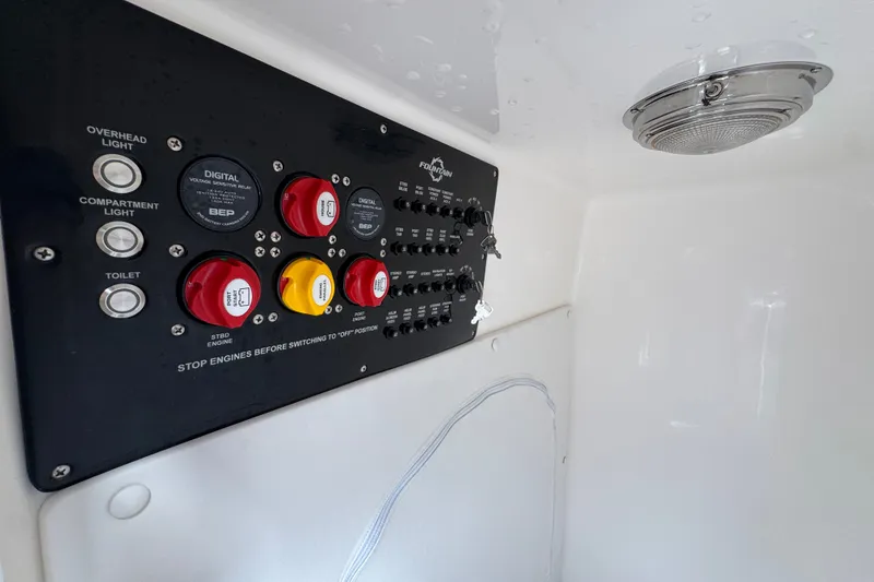 Slide: The Image of Control panel of 2024 Fountain 34 Center Console boat with switches and indicators. - 30