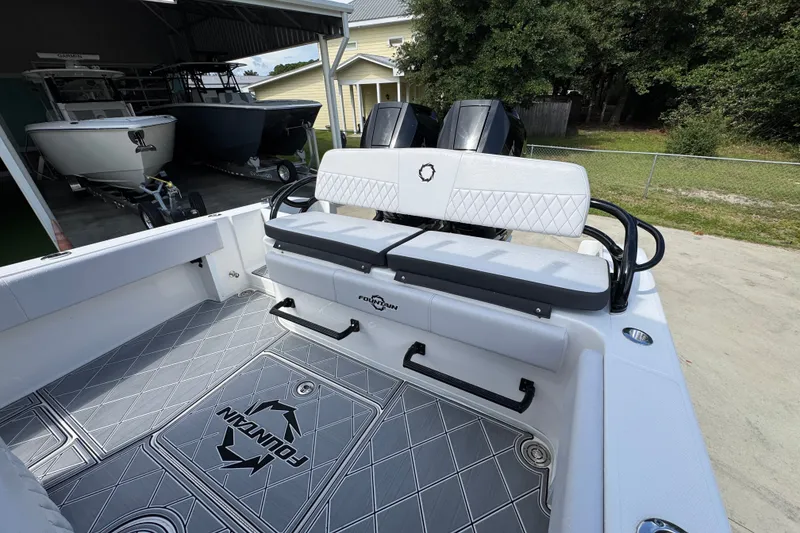 Slide: The Image of 2024 Fountain 34 Center Console boat interior with cushioned seating and sleek design. - 43
