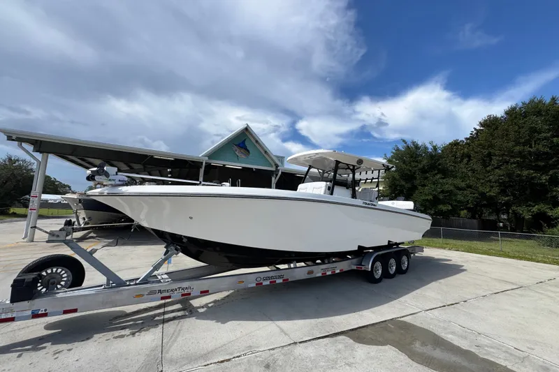 Slide: The Image of 2024 Fountain 34 Center Console boat on trailer under cloudy sky. - 4