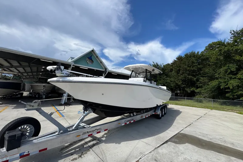 Slide: The Image of 2024 Fountain 34 Center Console boat on trailer under clear blue sky. - 5
