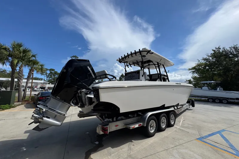 Slide: The Image of 2024 Fountain 34 Center Console boat on trailer under clear blue sky. - 14
