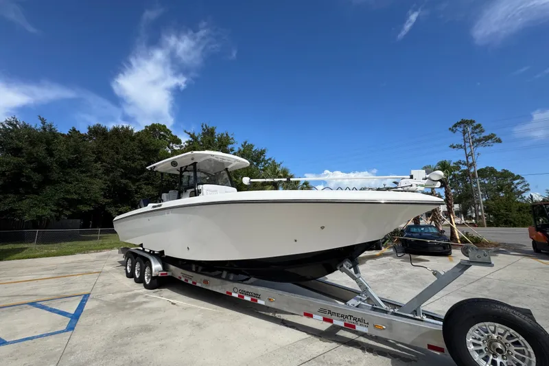 Slide: The Image of 2024 Fountain 34 Center Console boat on trailer under clear blue sky. - 9