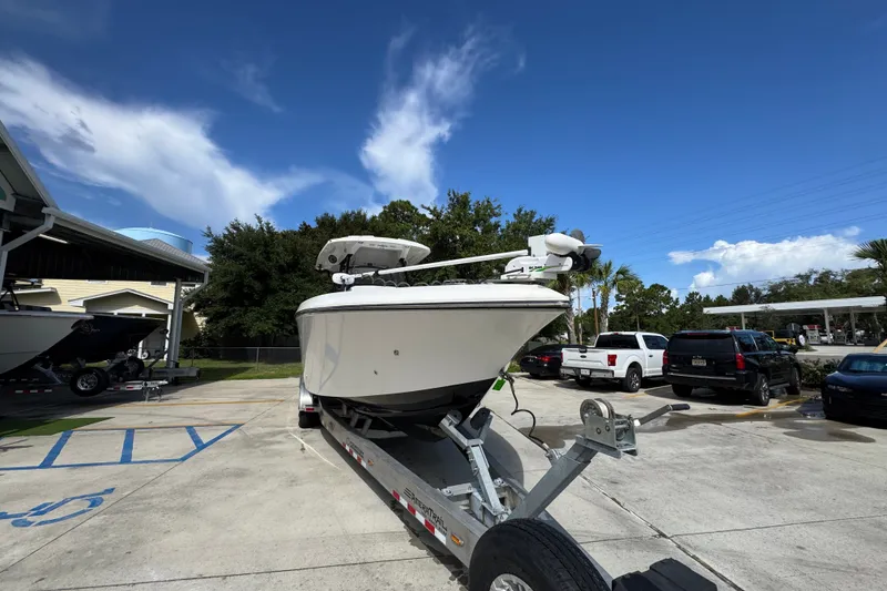 Slide: The Image of 2024 Fountain 34 Center Console boat on trailer under clear blue sky. - 8