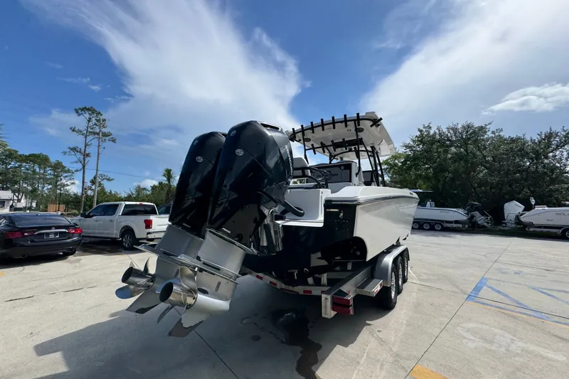 Slide: The Image of 2024 Fountain 34 Center Console boat on trailer, featuring dual outboard engines. - 15