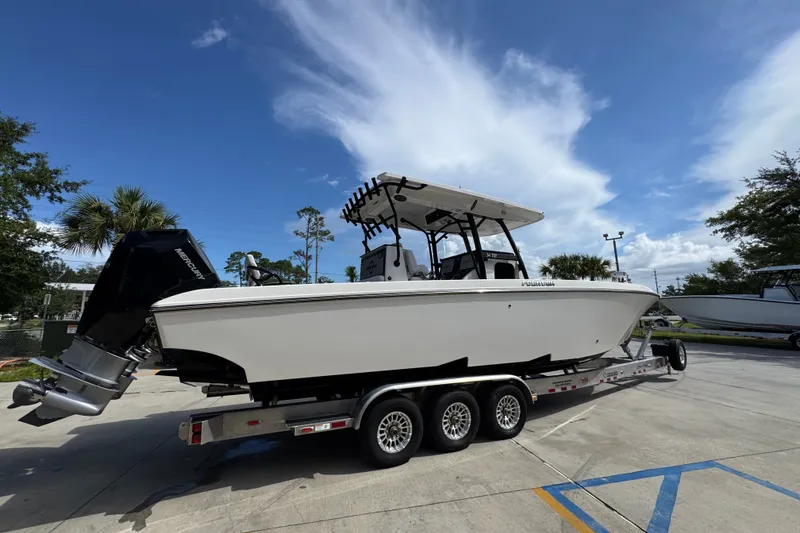Slide: The Image of 2024 Fountain 34 Center Console boat on trailer under clear blue sky. - 13