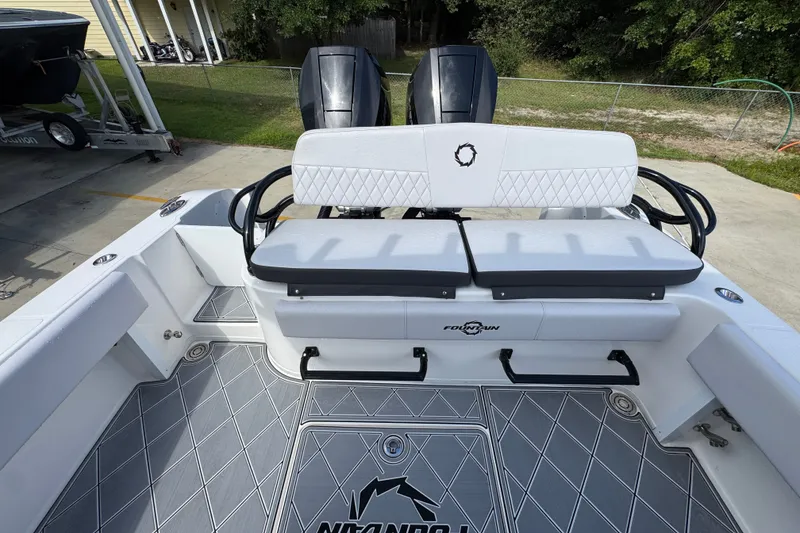 Slide: The Image of 2024 Fountain 34 Center Console boat interior with cushioned seating and dual engines. - 44