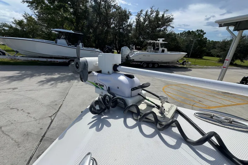 Slide: The Image of 2024 Fountain 34 Center Console boat with trolling motor, parked outdoors. - 23