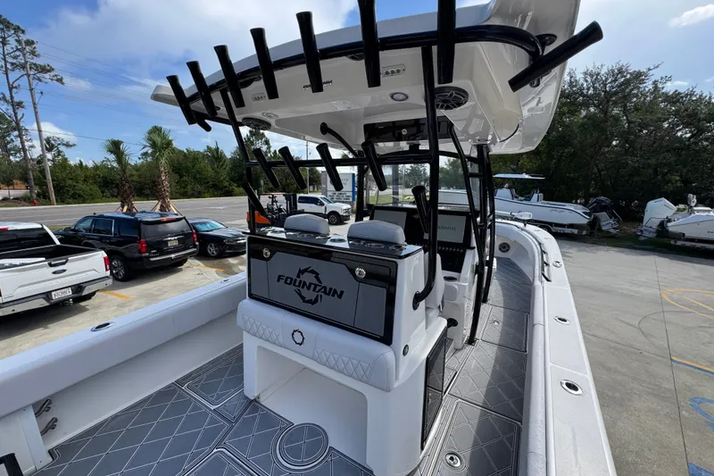 Slide: The Image of 2024 Fountain 34 Center Console boat with sleek design and modern features, docked outdoors. - 42