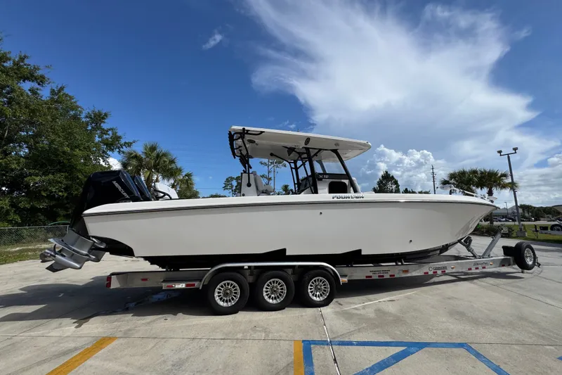 Slide: The Image of 2024 Fountain 34 Center Console boat on trailer under clear blue sky. - 12