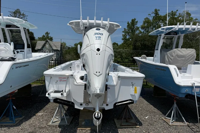 Slide: The Image of 2027 Sportsman Masters 247 Bay Boat with powerful outboard engine, displayed outdoors. - 13