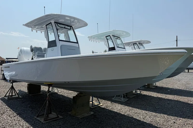 The Image of 2027 Sportsman Masters 247 Bay Boat displayed on stands in a gravel lot. - 0