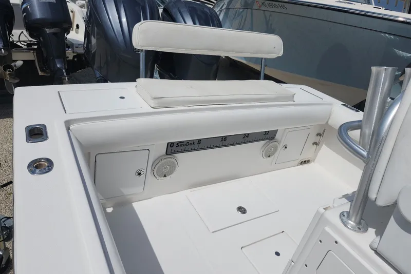 Slide: The Image of 2005 Regulator 26 Forward Seating boat interior with storage compartments and seating. - 16