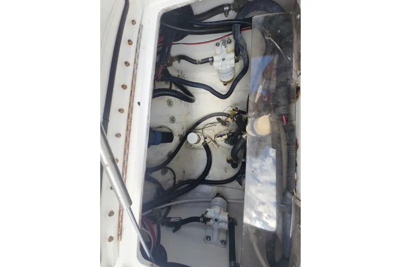 Slide: The Image of Engine compartment of a 2005 Regulator 26 Forward Seating boat, showing wiring and components. - 23