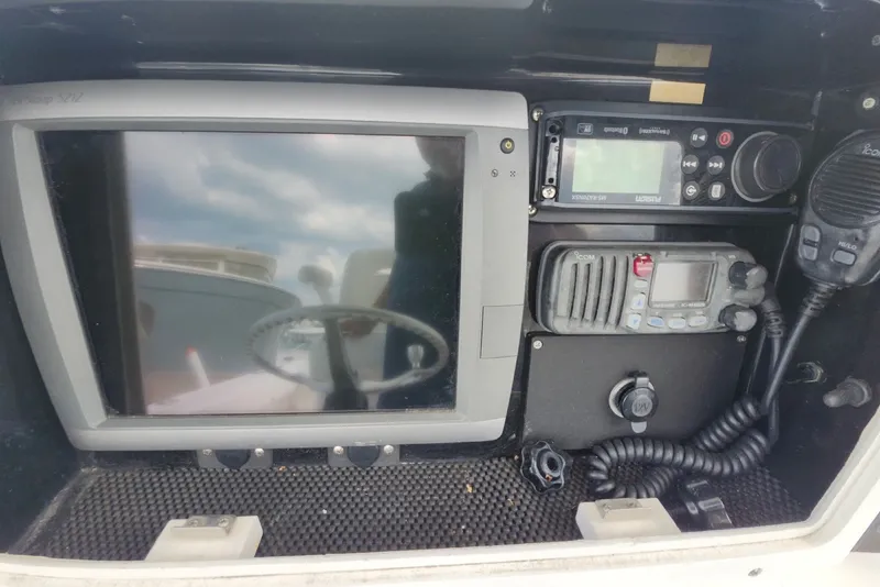 Slide: The Image of Control panel of a 2005 Regulator 26 Forward Seating boat with navigation equipment. - 13