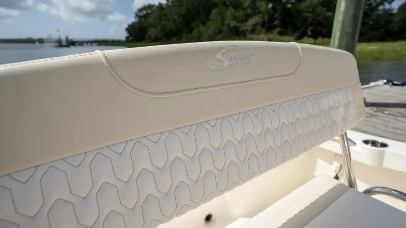 Slide: The Image of Close-up of the cream upholstery on a Scout 188 Sportfish boat, featuring quilted pattern and logo. - 12