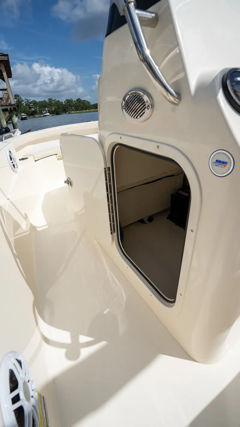 Slide: The Image of Scout 188 Sportfish 2027 with open storage hatch and view of the water. - 9