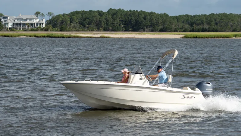 Slide: The Image of Scout 188 Sportfish 2027 on the water with two people on board. - 43