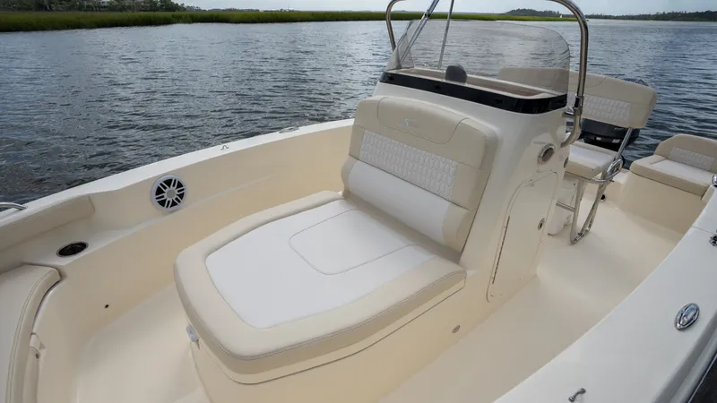 Slide: The Image of Scout 188 Sportfish 2027 with beige upholstery and helm console on calm water. - 6