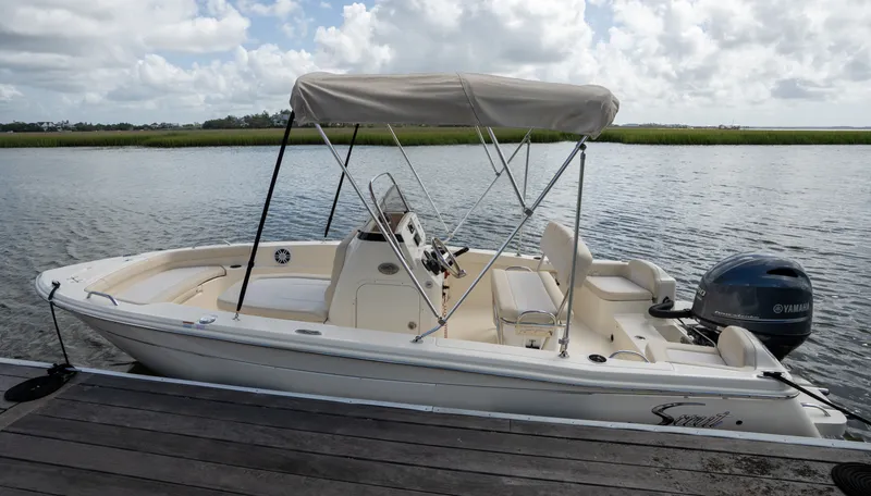 Slide: The Image of Scout 188 Sportfish 2027 at dock, featuring a sunshade and Yamaha engine. - 17