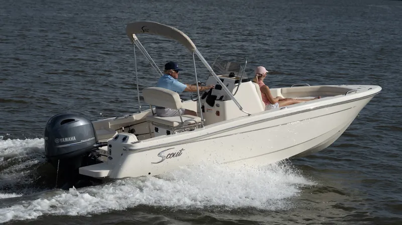 Slide: The Image of A 2027 Scout 188 Sportfish boat on the water with two people on board. - 41