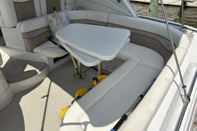 Slide: The Image of 2005 Four Winns 348 Vista boat interior with white seating and table. - 14