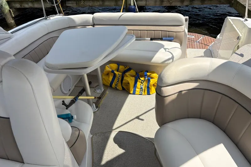 Slide: The Image of 2005 Four Winns 348 Vista boat interior with beige seating and table. - 7
