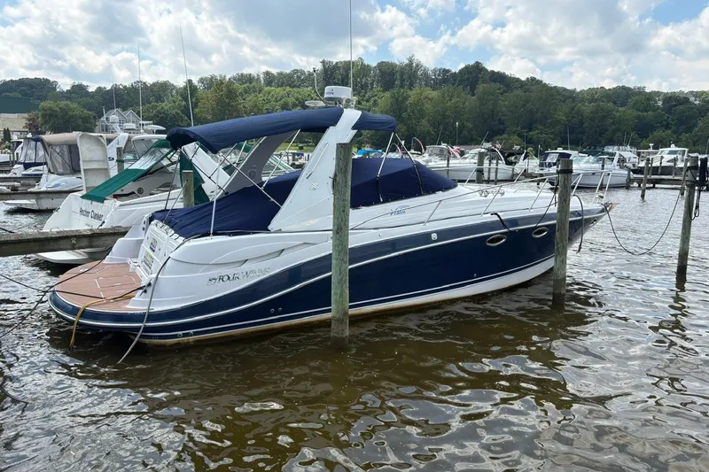 The Image of 2005 Four Winns 348 Vista boat docked at marina, surrounded by other vessels. - 0