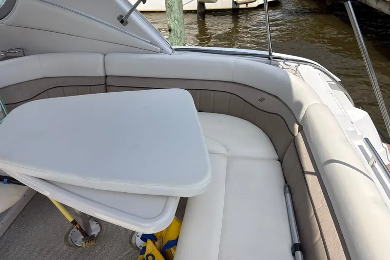 Slide: The Image of 2005 Four Winns 348 Vista boat interior with cushioned seating and table. - 13