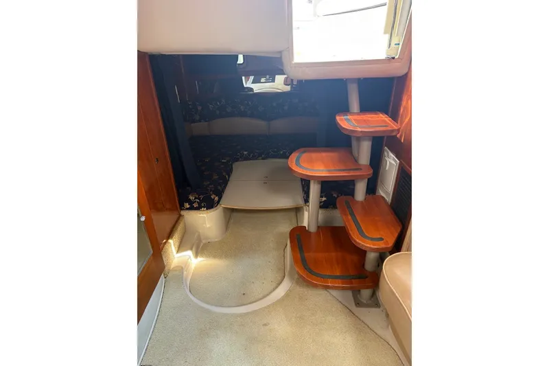 Slide: The Image of Interior of 2005 Four Winns 348 Vista boat with wooden steps and cozy seating area. - 16