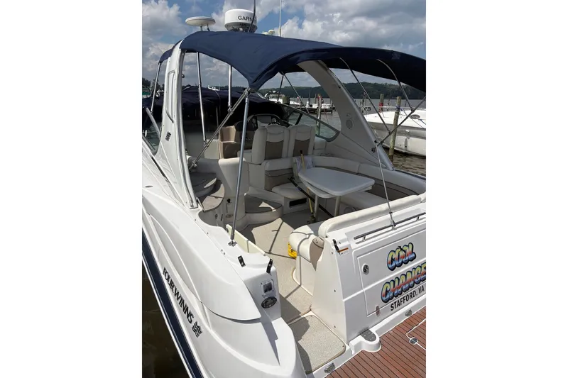 Slide: The Image of 2005 Four Winns 348 Vista boat with blue canopy docked at marina. - 15