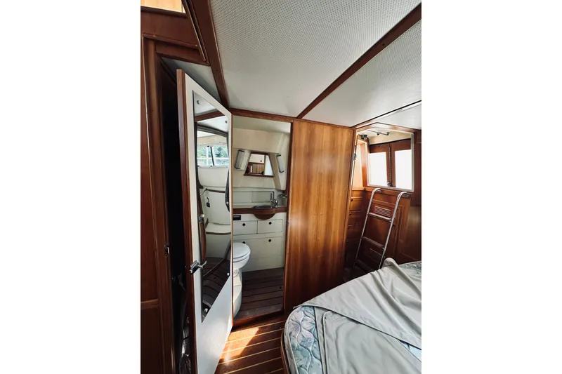 Slide: The Image of Interior of 1996 Sabreline 36 Sedan yacht featuring a compact bathroom and wooden cabinetry. - 52