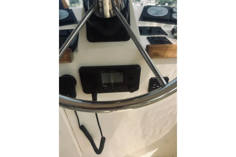 Slide: The Image of Steering wheel and controls of a 1996 Sabreline 36 Sedan boat. - 93