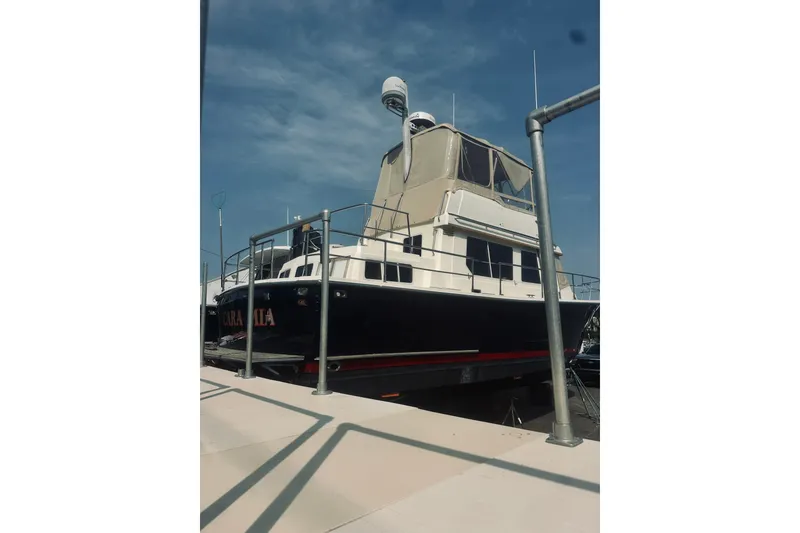 Slide: The Image of 1996 Sabreline 36 Sedan yacht docked under a clear blue sky. - 3